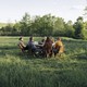 People sitting a table in a park