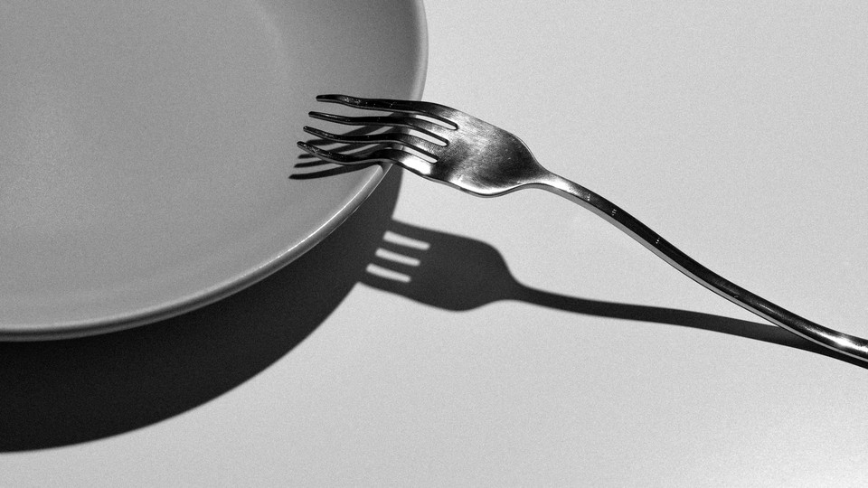A fork breaking against a plate