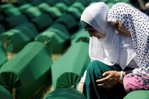 Muslim women mourn on July 11, 2016, near coffins of newly identified victims of the 1995 Srebrenica massacre.