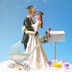 An illustration of husband and wife figurines on a cake, with a stroller, graduation caps, and a mailbox full of money