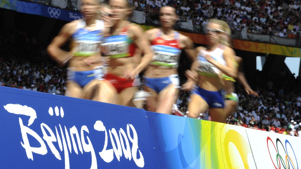 Runners appear blurry in this photo of competitors of a track event at the Beijing Olympics in 2008