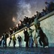 West Berliners help East Germans over the Berlin Wall.