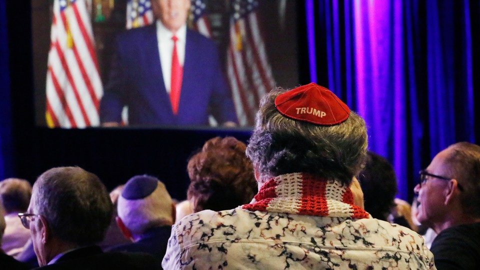 A Jewish Trump supporter is seen from behind sitting in a crowd