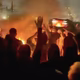 A frame grab from footage circulating on social media showing protesters dancing and cheering around a bonfire in Tehran, Iran.
