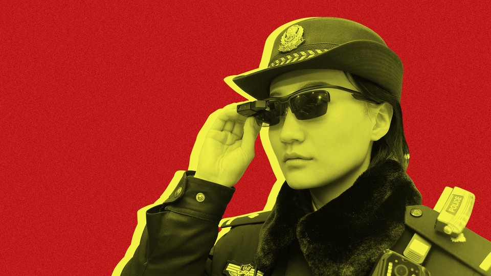 A police officer wearing a pair of "smart glasses" with a facial-recognition system at Zhengzhou East Railway Station in China