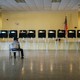 An election official sits in a chair while waiting for voters to arrive at a polling station in Miami, Florida, U.S., on Tuesday, March 17, 2020. Voters in Florida, Illinois and Arizona were trickling into the polls Tuesday as the coronavirus pandemic continued to wreak havoc on the Democratic presidential primary calendar with Ohio postponing its contest, citing a public health emergency.