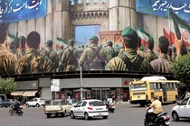 A large mural of Iranian soldiers looms over a commercial intersection in Tehran.