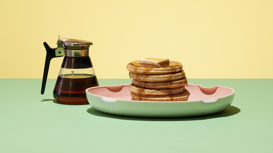 A stack of pancakes and syrup