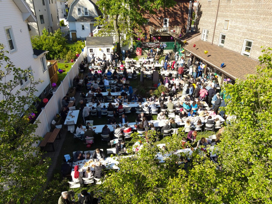 People gather in a courtyard to eat together.