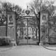 An archival photograph of Harvard University's main gate