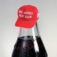 An illustration of a Coca-Cola bottle with a MAGA hat