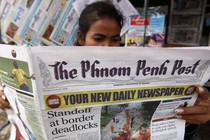 A woman reads The Phnom Penh Post in Cambodia