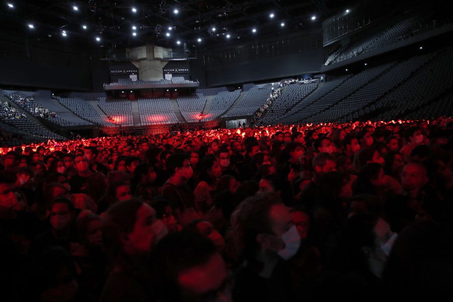 Hundreds of people gather in a stadium.