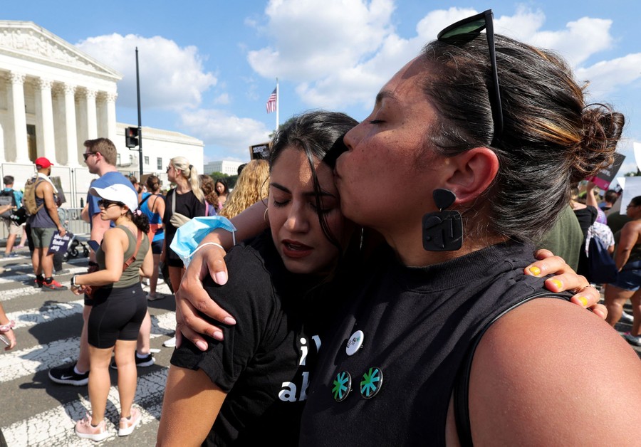 Two women embrace each other during a protest in front of the United States Supreme Court building.