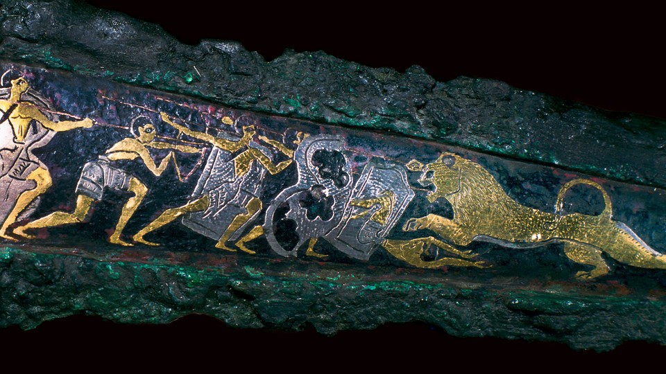 A Mycenaean bronze dagger showing a lion hunt