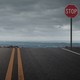 photo of a road with a stop sign ending at a cliff
