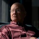 Pastor Tim Keller sits partially in shadow.