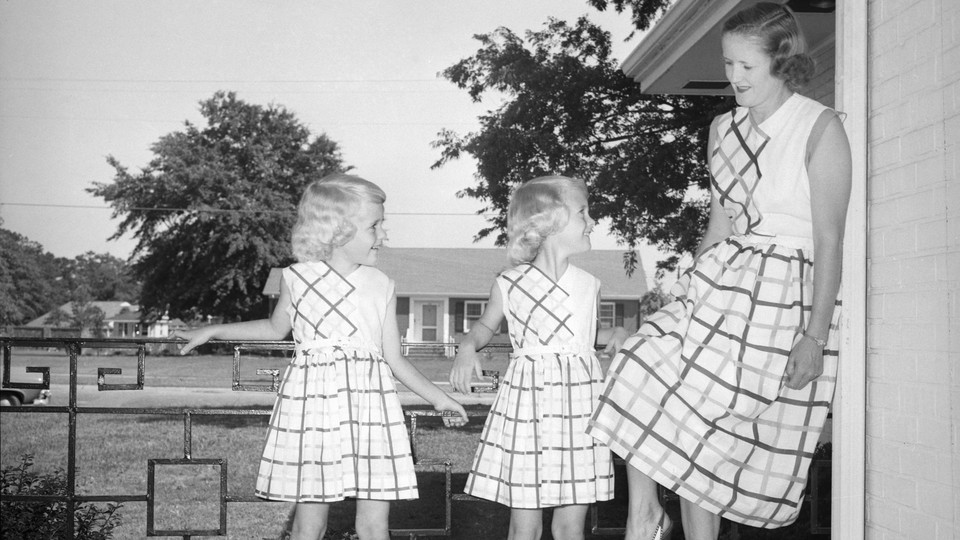 A mom and her daughters pose in the front of their Southern California home in the early 1950s