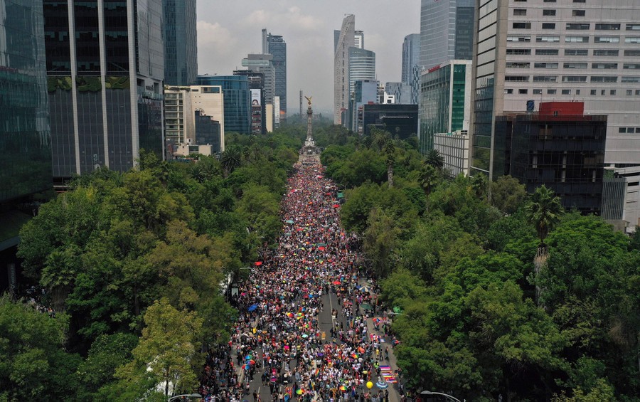 An aerial view of a city street packed with marchers
