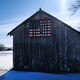 A barn in Iowa decorated with an American flag.