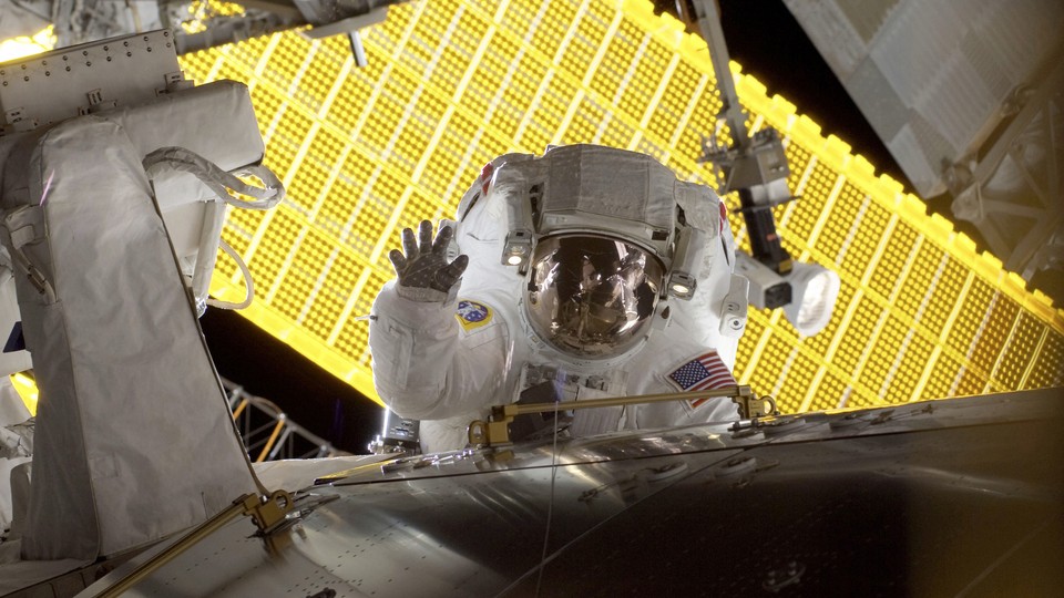 Astronaut Nicole Stott waves during a spacewalk outside the International Space Station in 2009.