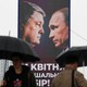 People walk past a campaign billboard, showing Poroshenko and Putin, in Kyiv.