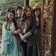 Four women in a Chinese garden looking offscreen in a scene from 'Joy Ride'