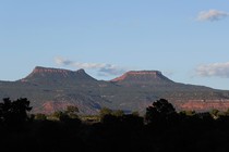 The two bluffs, known as the 'Bears Ears,' stand off in the distance at sunset in the Bears Ears National Monument