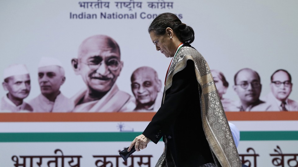 Sonia Gandhi walks to address her party workers at the All India Congress Committee meeting in New Delhi on January 17, 2014. 