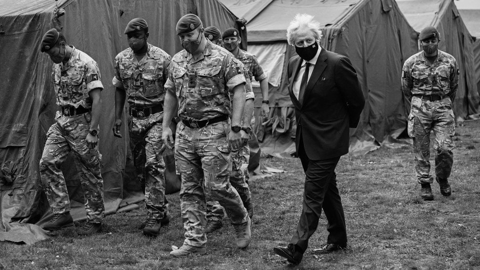 Boris Johnson walks alongside British troops.