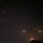 Iranian projectiles streak across the night sky.