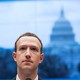 Mark Zuckerberg looks ahead in front of an image of Capitol Hill