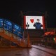 A large monitor shows an image of Chinese president Xi Jinping wearing a mask in an empty station.