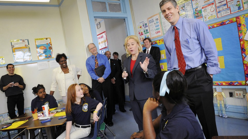 Former U.S. Education Secretary Arne Duncan smiles while meeting with fourth-graders in a New Orleans charter school in 2009.