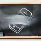 A chalkboard with a picture of a phone that's half erased