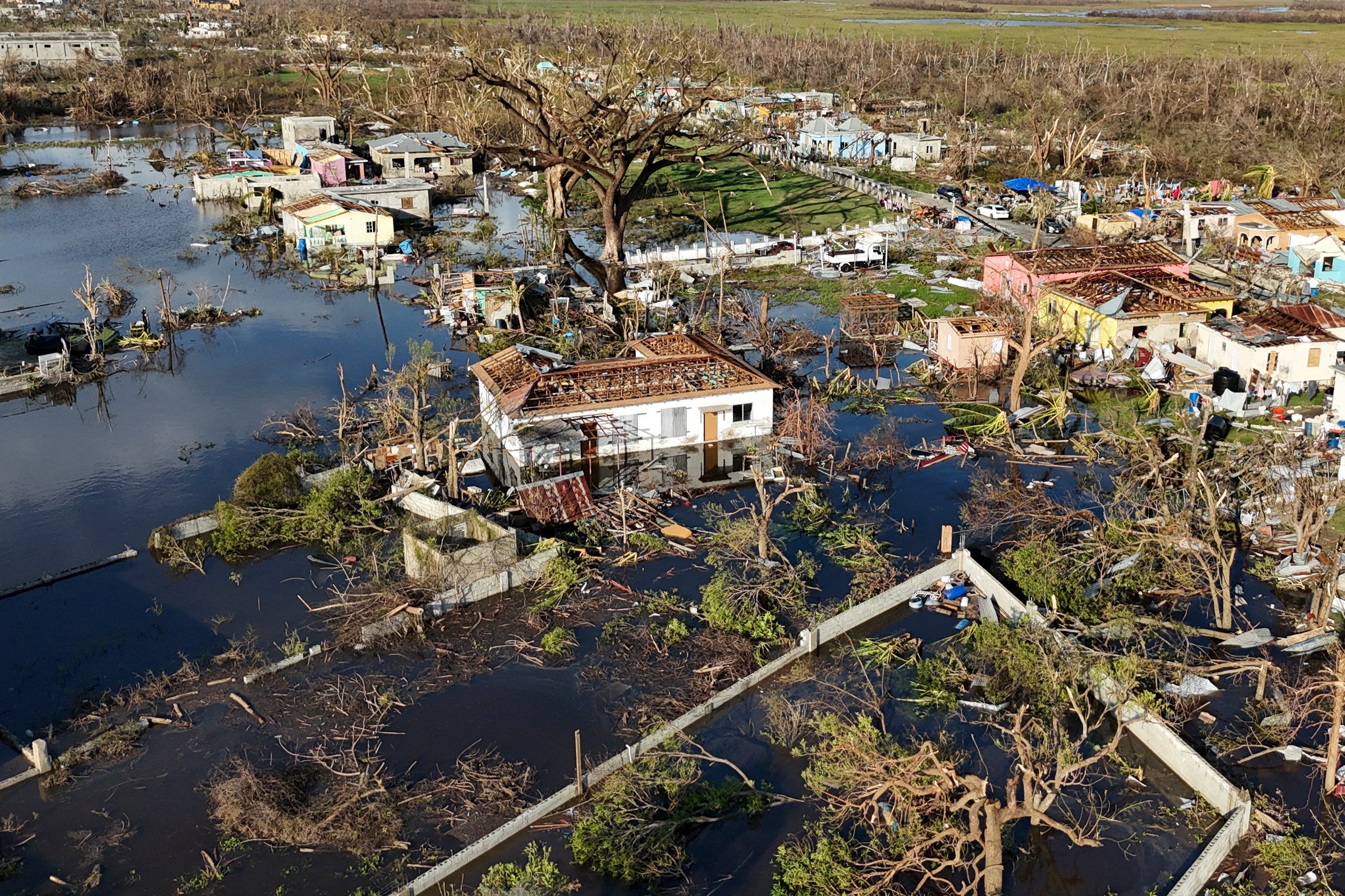 An aerial view of a coastal neighborhood, devastated by a recent storm