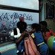 Kids looking out the window in the New York subway
