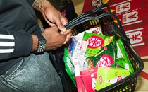 A person carries a grocery basket of KitKats.