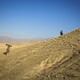 U.S. soldiers climb a hill in Afghanistan