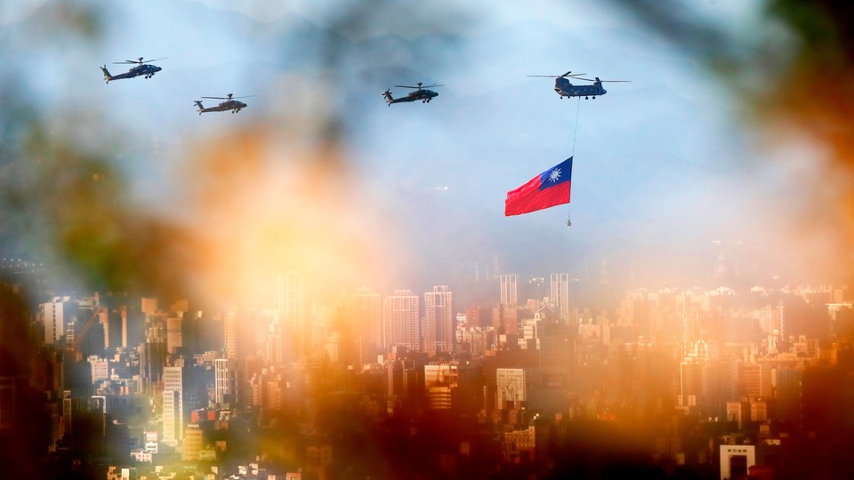 Military helicopters carrying Taiwan flags conduct a flyby rehearsal ahead of National Day celebration, near Taipei 101 , amid escalating tensions between Taipei and Beijing, China, in Taipei, Taiwan, on October 5, 2021.