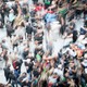 A blurry crowd of people moving around.