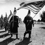 Ku Klux Klan members march in cemetery funeral rites in Chesapeake, Virginia, in 1966.