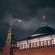 An image of the Kremlin in front of a cloudy dark night sky