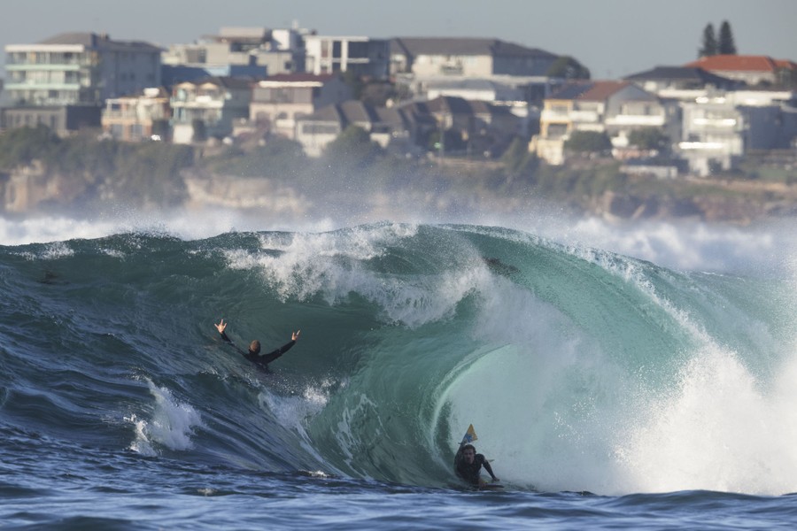 Surfers enjoy large waves.