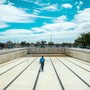 A man walks along the bottom of an empty public swimming pool near Cape Town.