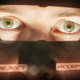 A close-up of a man's face with the eyes illuminated and the words "reject" and "accept" superimposed on his cheeks