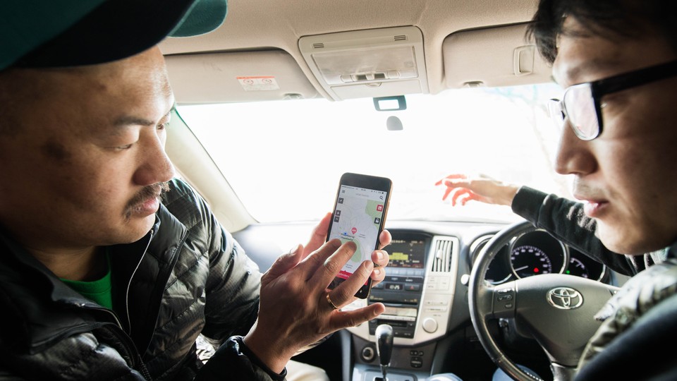Two men demonstrate the Mongolian-language version of What3Words in downtown Ulaanbaatar.