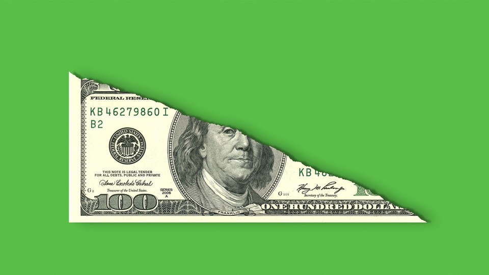 A $100 bill that has been torn in half diagonally