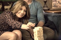 A still from the movie Game Night, showing Sharon Horgan playing Jenga