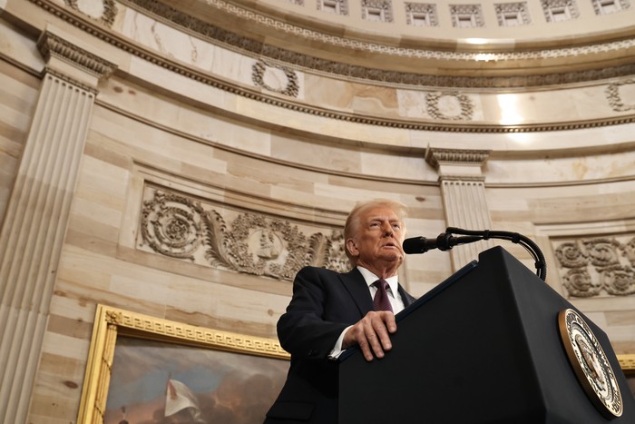 Donald Trump stands at a podium to speak